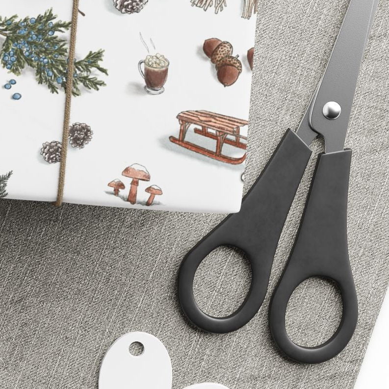 Gift wrap with nature-themed design, yarn ball, scissors, and tags on a gray surface